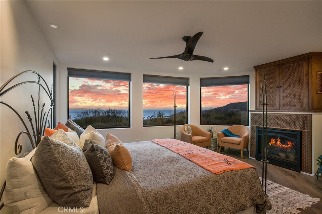 825 Coast View Drive Laguna Beach, CA 92651 - Photo 35 of 63 a bed room with a bed and a large window