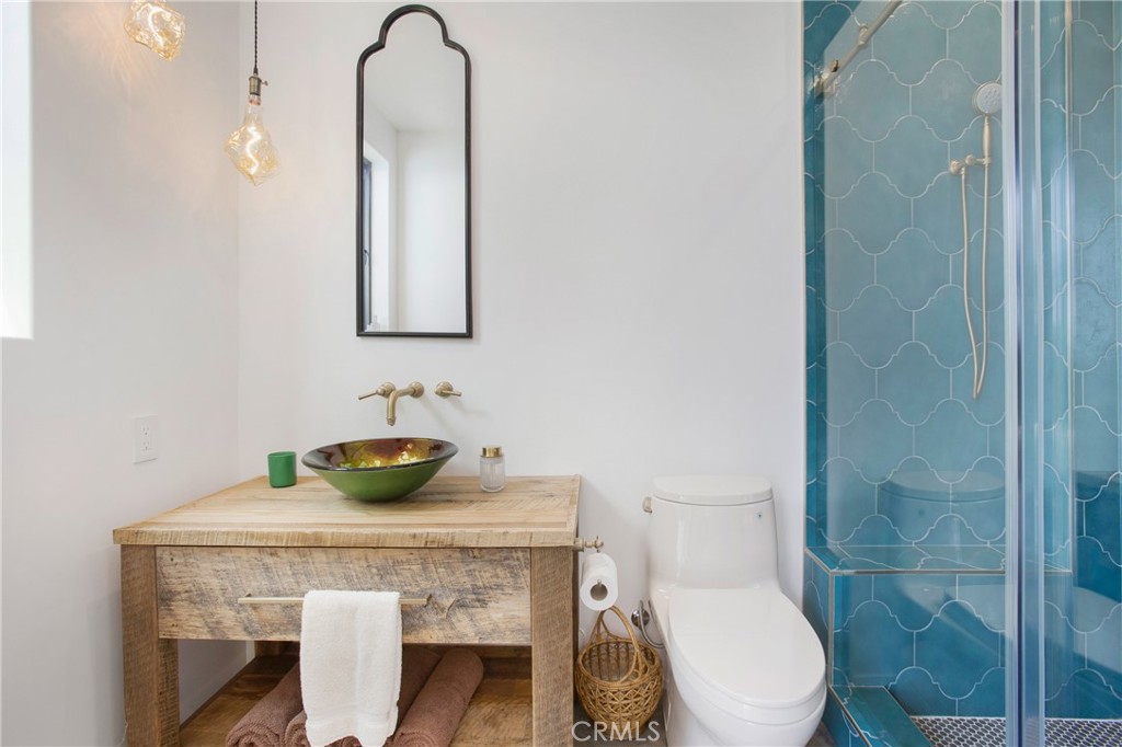 825 Coast View Drive Laguna Beach, CA 92651 - Photo 46 of 63 a bathroom with a toilet a sink and mirror