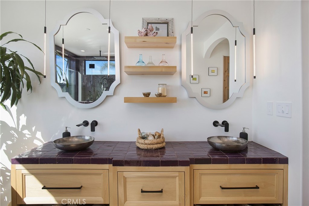 825 Coast View Drive Laguna Beach, CA 92651 - Photo 53 of 63 a kitchen with white cabinets and appliances