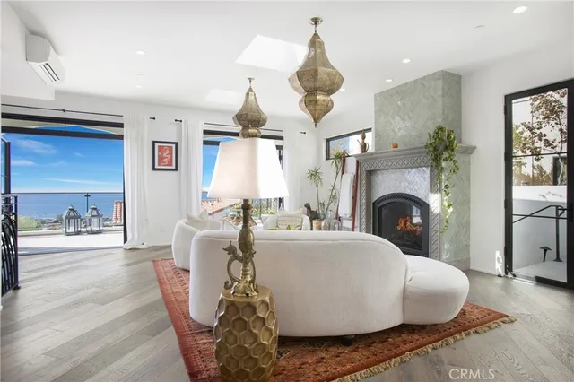 a living room with furniture wooden floor and a fireplace