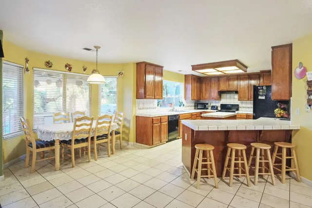 a large kitchen with a table and chairs