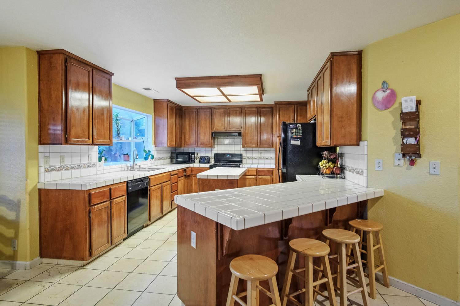 2805 Medinah Way Modesto, CA 95355 - Photo 12 of 39 a kitchen with granite countertop kitchen island stainless steel appliances a sink stove and refrigerator