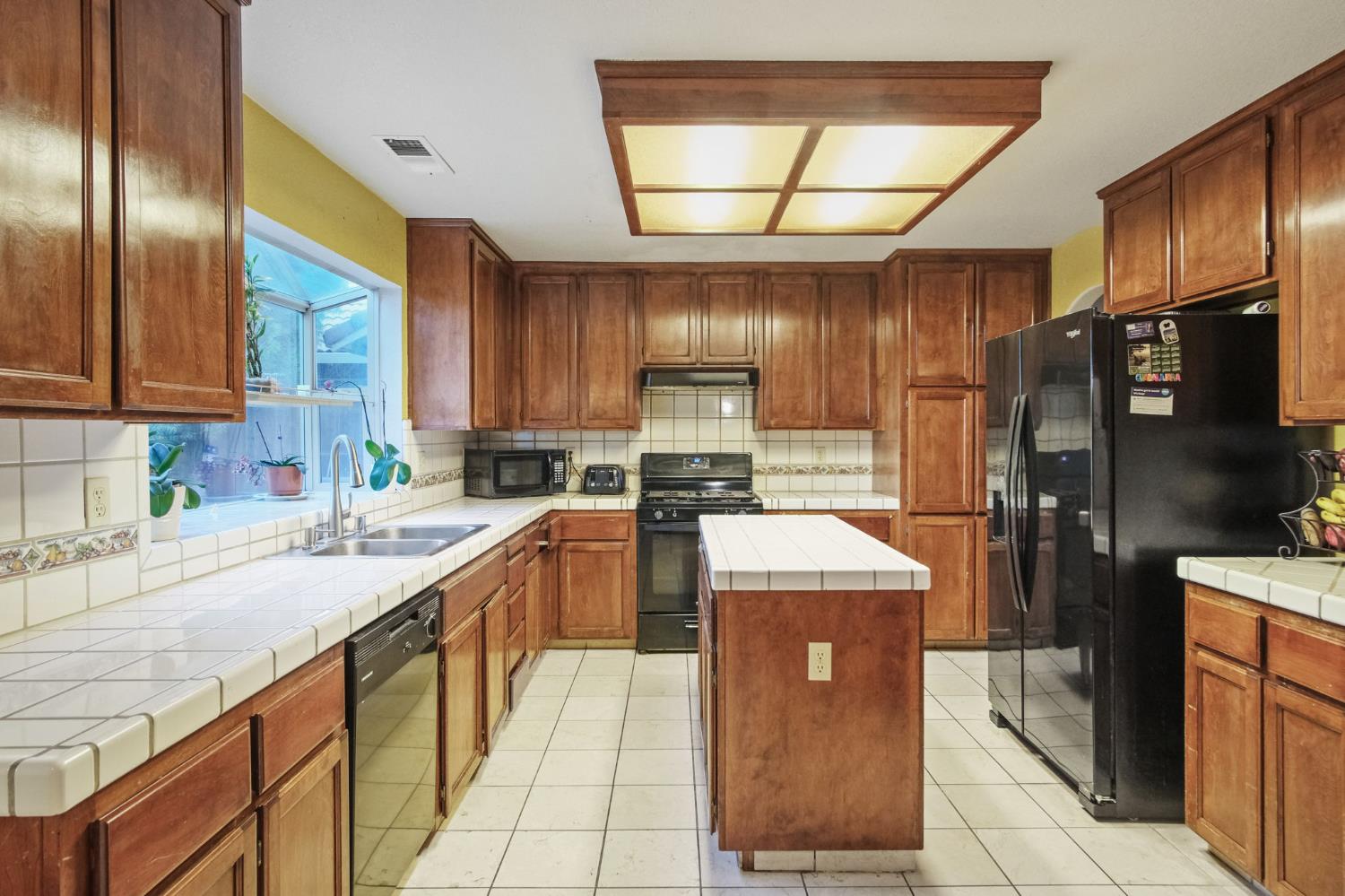 2805 Medinah Way Modesto, CA 95355 - Photo 13 of 39 a kitchen with stainless steel appliances granite countertop wooden cabinets a sink and a stove