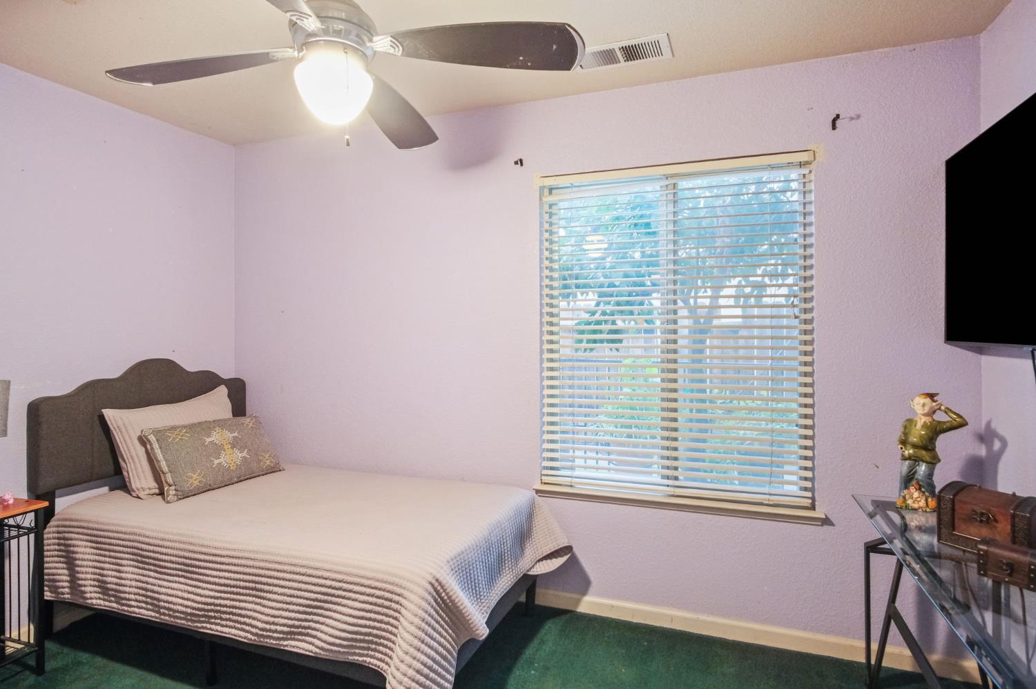 2805 Medinah Way Modesto, CA 95355 - Photo 17 of 39 a bedroom with a bed a flat screen tv and a window