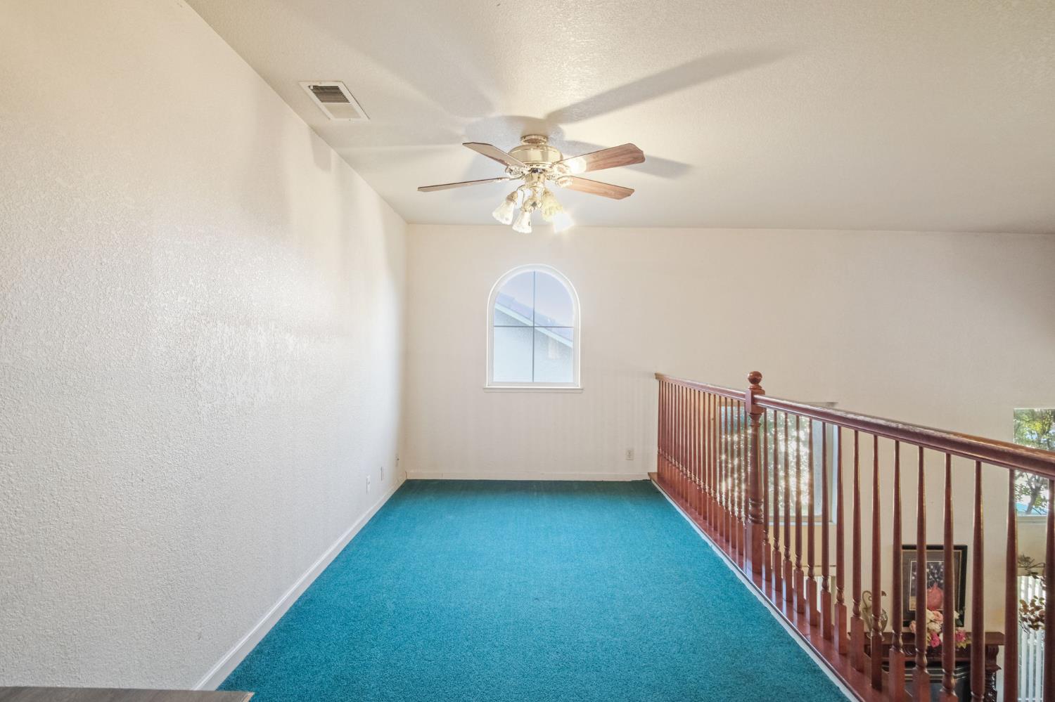 2805 Medinah Way Modesto, CA 95355 - Photo 19 of 39 a view of a hallway with a window and a chandelier fan