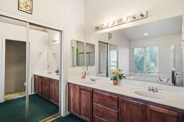 a bathroom with a double vanity sink mirror and double
