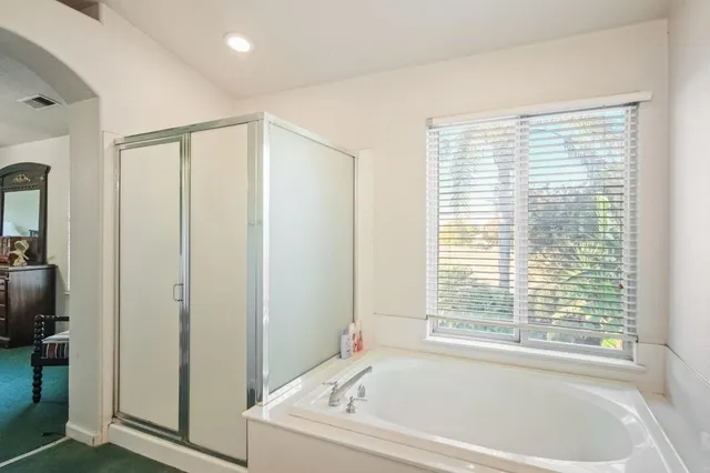 a white bath tub sitting next to a window