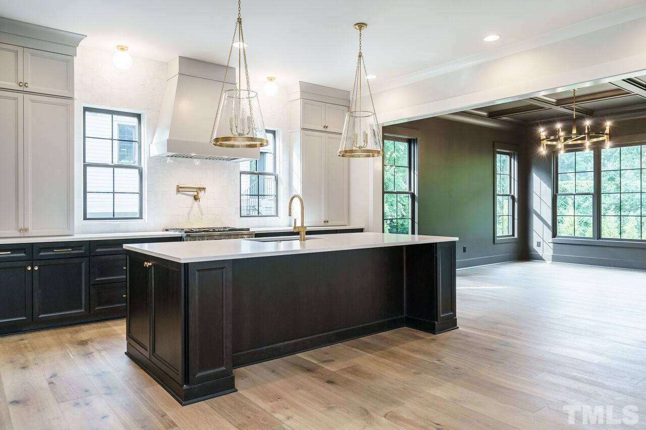 2535 Wake Drive Raleigh, NC 27608 - Photo 11 of 51 a kitchen with stainless steel appliances granite countertop wooden cabinets a stove a sink and a large window