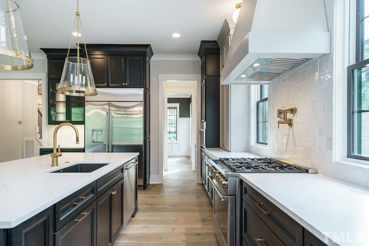 2535 Wake Drive Raleigh, NC 27608 - Photo 12 of 51 a kitchen with stainless steel appliances granite countertop a sink and a refrigerator