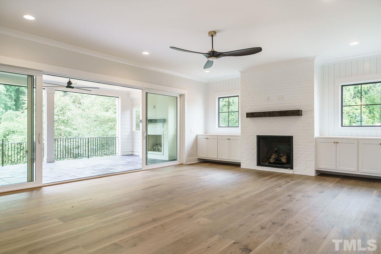 2535 Wake Drive Raleigh, NC 27608 - Photo 16 of 51 a view of empty room with wooden floor and fireplace