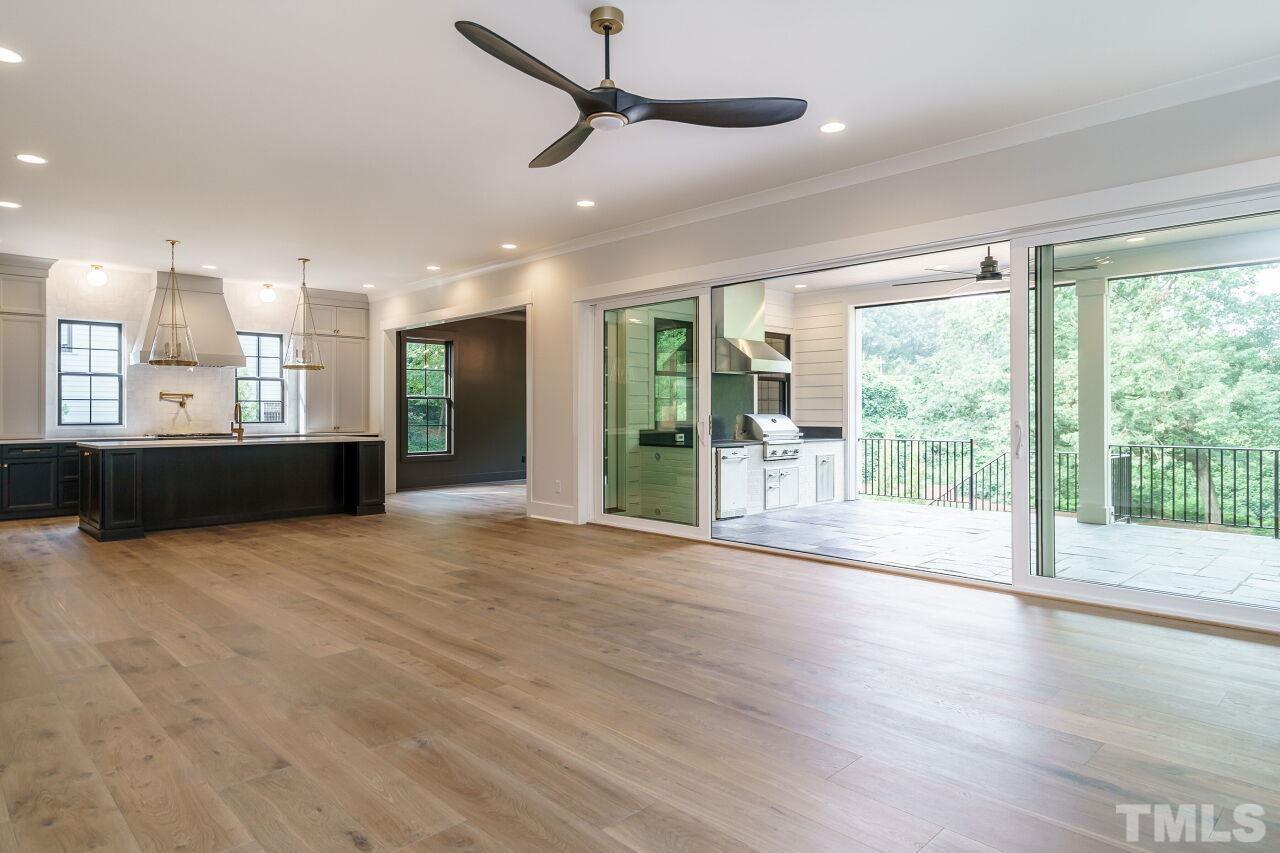 2535 Wake Drive Raleigh, NC 27608 - Photo 20 of 51 a view of an empty room with wooden floor and a floor to ceiling window