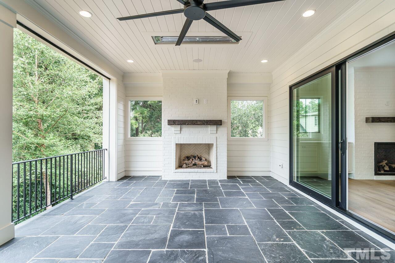 2535 Wake Drive Raleigh, NC 27608 - Photo 21 of 51 a view of an empty room with a fireplace and a window