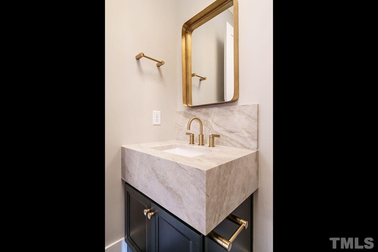 2535 Wake Drive Raleigh, NC 27608 - Photo 26 of 51 a bathroom with a sink vanity and a mirror