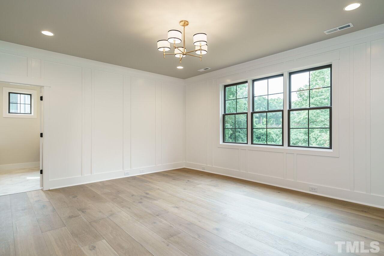 2535 Wake Drive Raleigh, NC 27608 - Photo 30 of 51 wooden floor in an empty room with a window