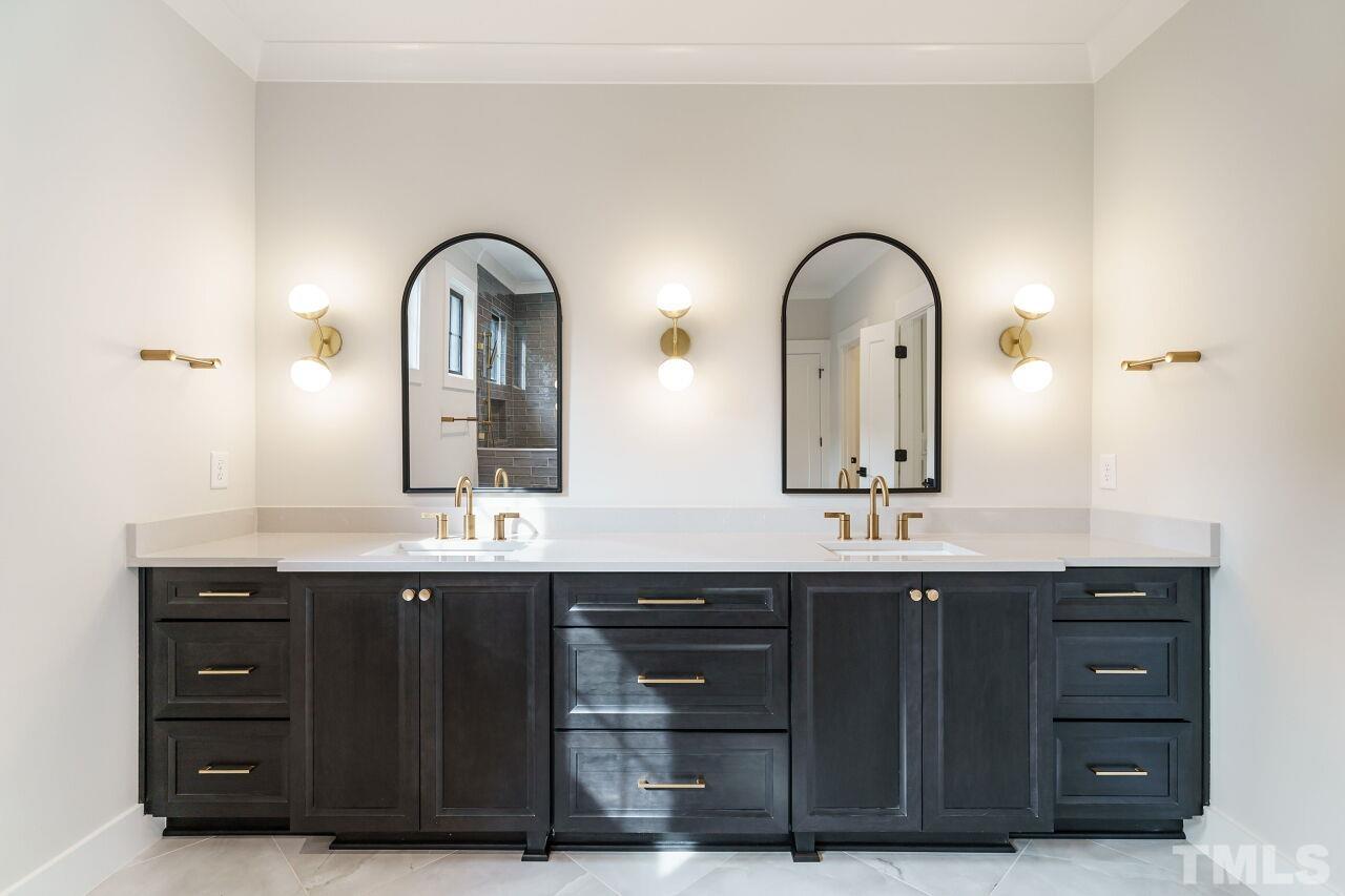 2535 Wake Drive Raleigh, NC 27608 - Photo 32 of 51 a bathroom with a double vanity sink and a mirror