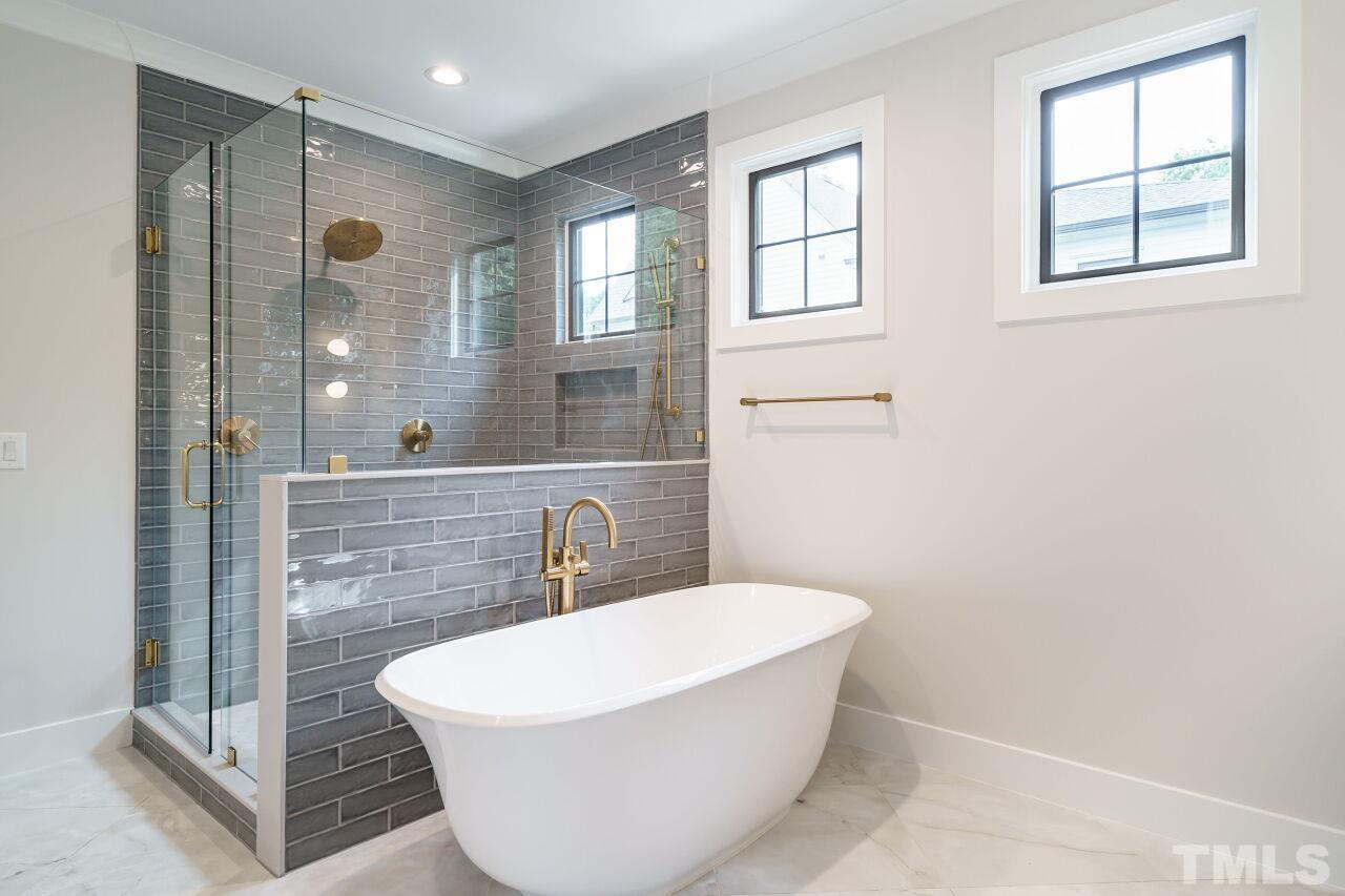 2535 Wake Drive Raleigh, NC 27608 - Photo 33 of 51 a white bath tub sitting in a bathroom next to a window