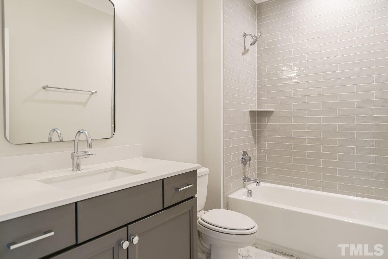 2535 Wake Drive Raleigh, NC 27608 - Photo 39 of 51 a bathroom with a sink a toilet and shower