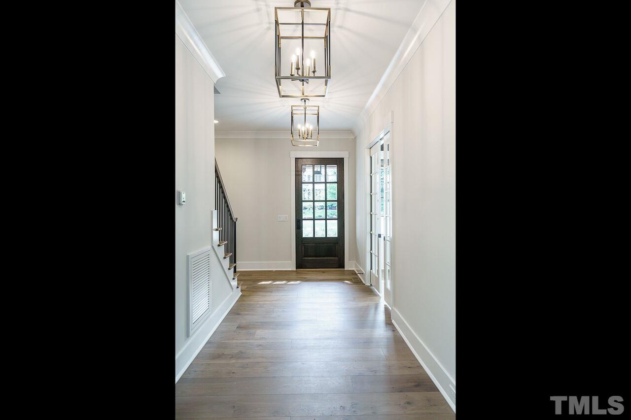 2535 Wake Drive Raleigh, NC 27608 - Photo 4 of 51 a view of a hallway with wooden floor and stairs