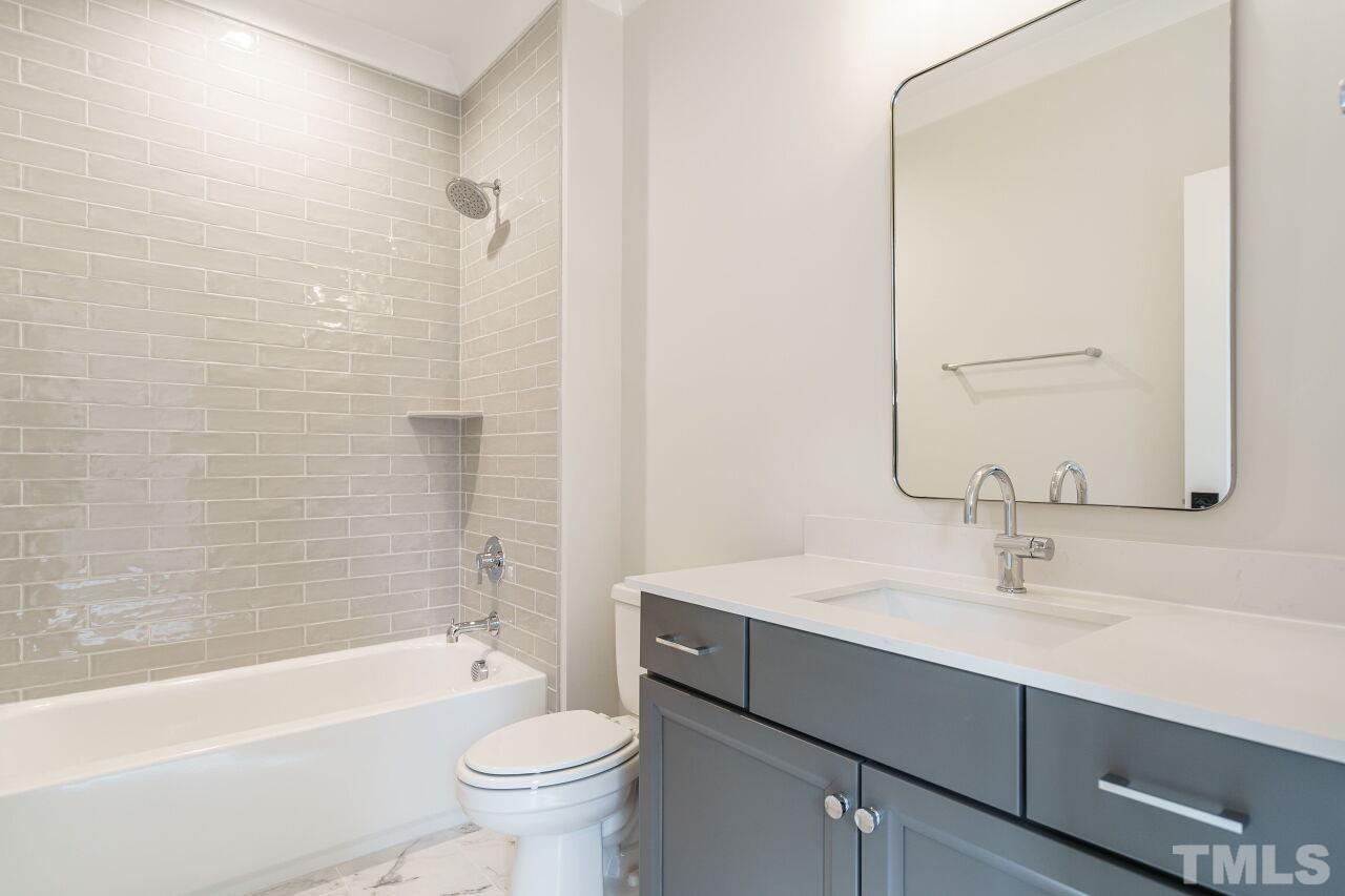 2535 Wake Drive Raleigh, NC 27608 - Photo 43 of 51 a bathroom with a sink a toilet and shower