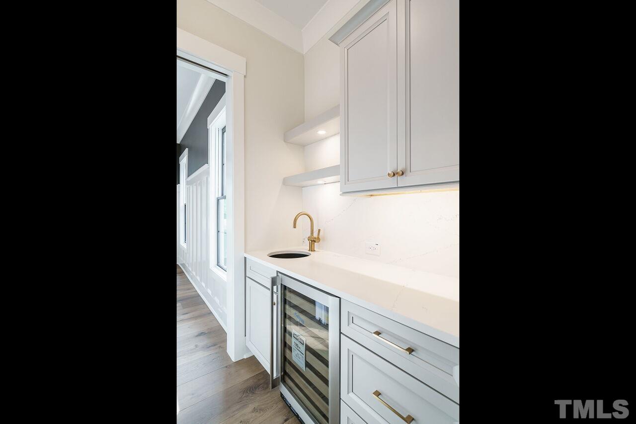 2535 Wake Drive Raleigh, NC 27608 - Photo 7 of 51 a view of a kitchen with white cabinets and a sink