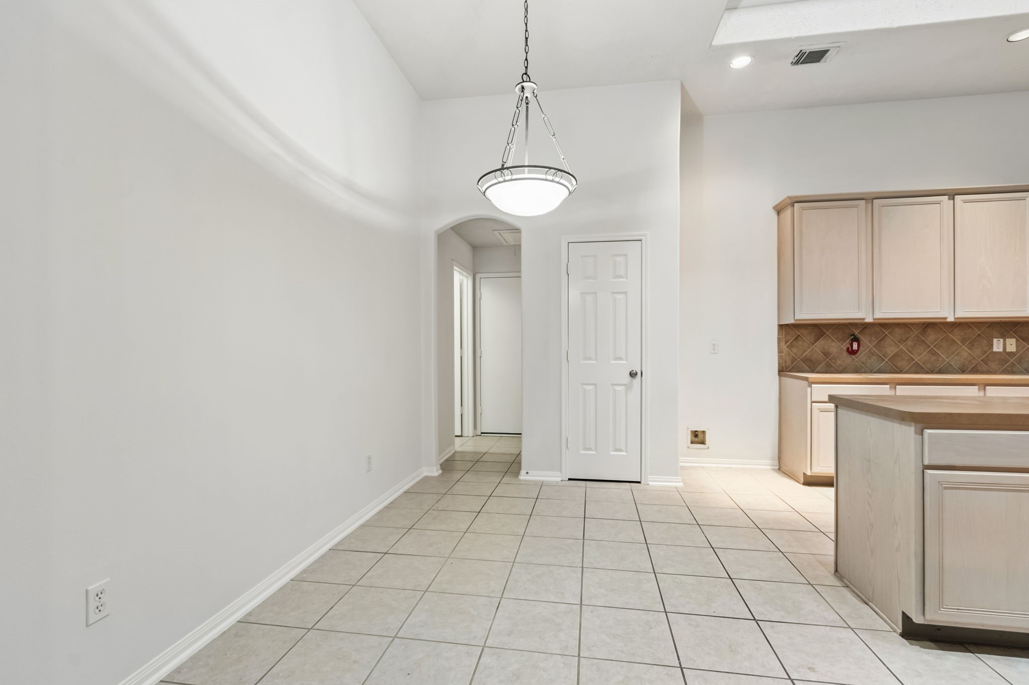 31235 Windcrest Park Lane Spring, TX 77386 - Photo 11 of 50 a view of an empty room with window and cabinet
