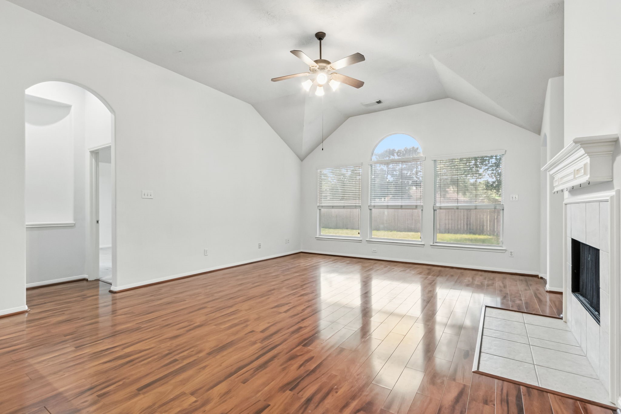 31235 Windcrest Park Lane Spring, TX 77386 - Photo 13 of 50 a view of an empty room with wooden floor and a window