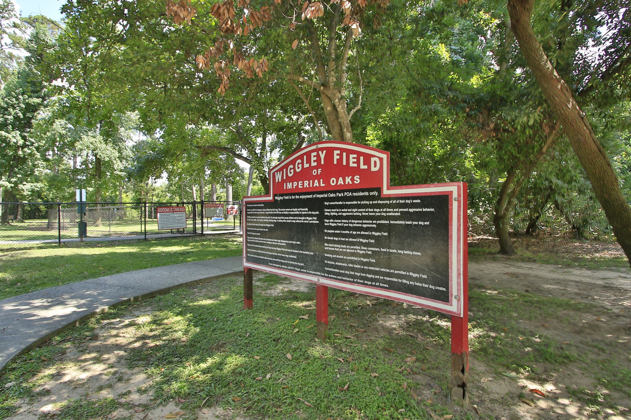 31235 Windcrest Park Lane Spring, TX 77386 - Photo 46 of 50 a wooden bench sitting in a park with large trees