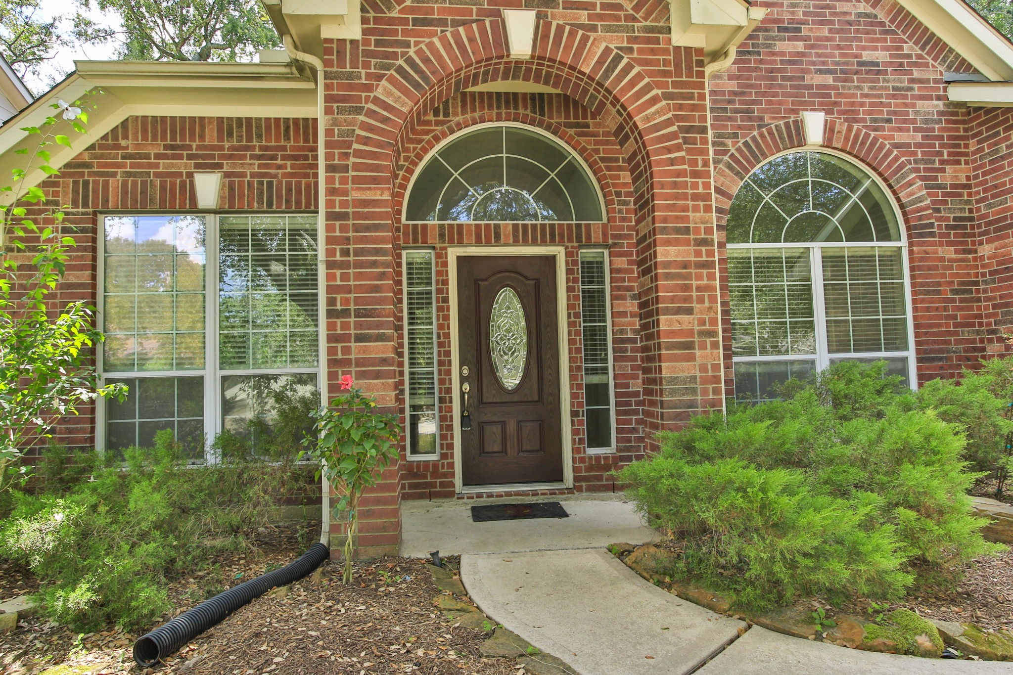 31235 Windcrest Park Lane Spring, TX 77386 - Photo 48 of 50 a front view of a house with garden