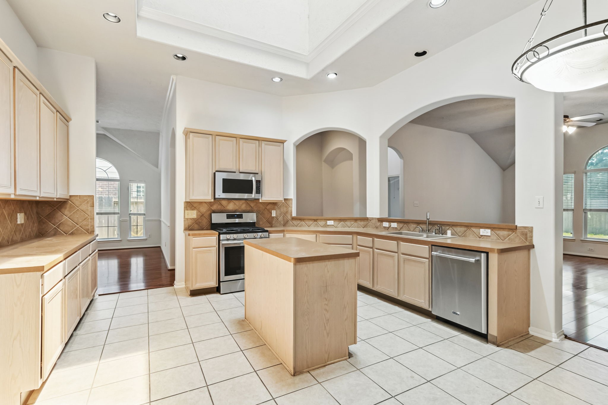 31235 Windcrest Park Lane Spring, TX 77386 - Photo 7 of 50 a kitchen with stainless steel appliances granite countertop a stove top oven a sink a counter space and cabinets