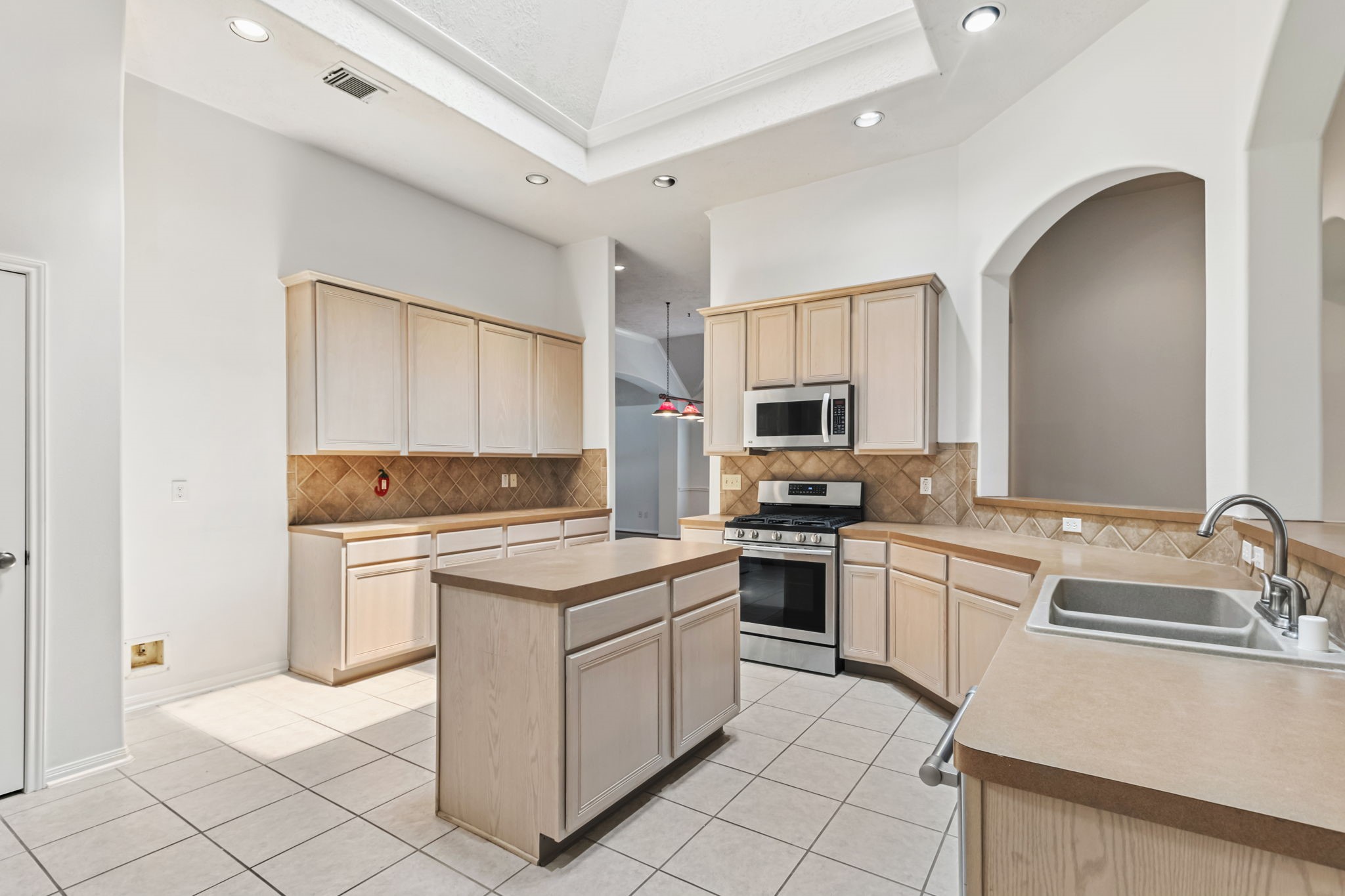 31235 Windcrest Park Lane Spring, TX 77386 - Photo 8 of 50 a kitchen with a stove sink and cabinets