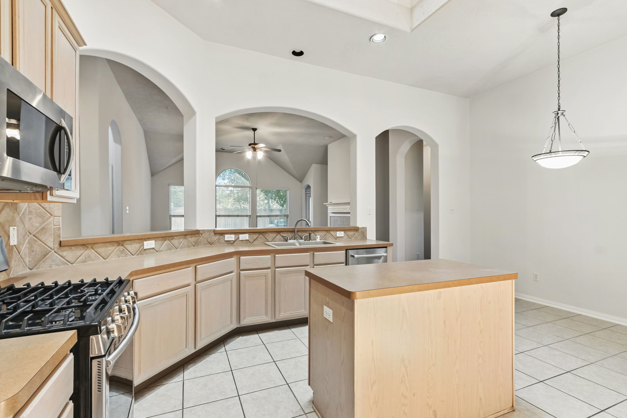31235 Windcrest Park Lane Spring, TX 77386 - Photo 9 of 50 a kitchen with a sink stove and cabinets