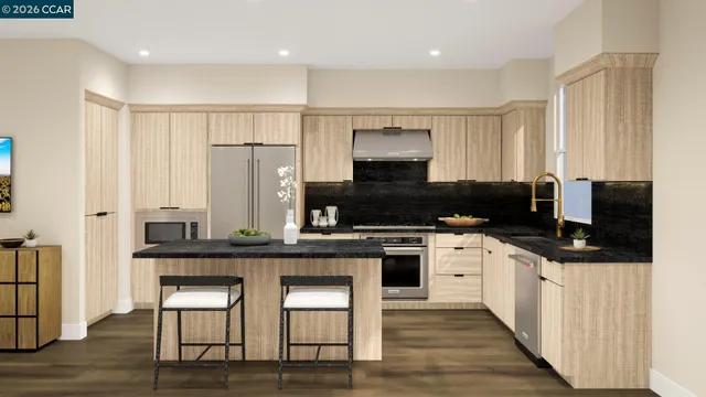 a kitchen with stainless steel appliances a stove a sink a microwave a refrigerator and cabinets