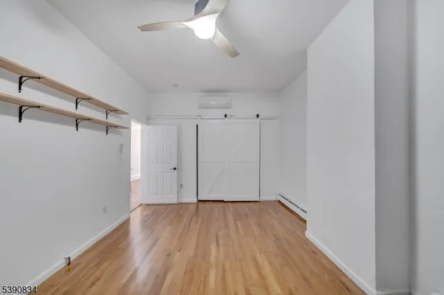 a view of a room with wooden floor