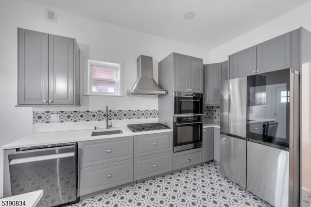 a kitchen with a sink stove and refrigerator