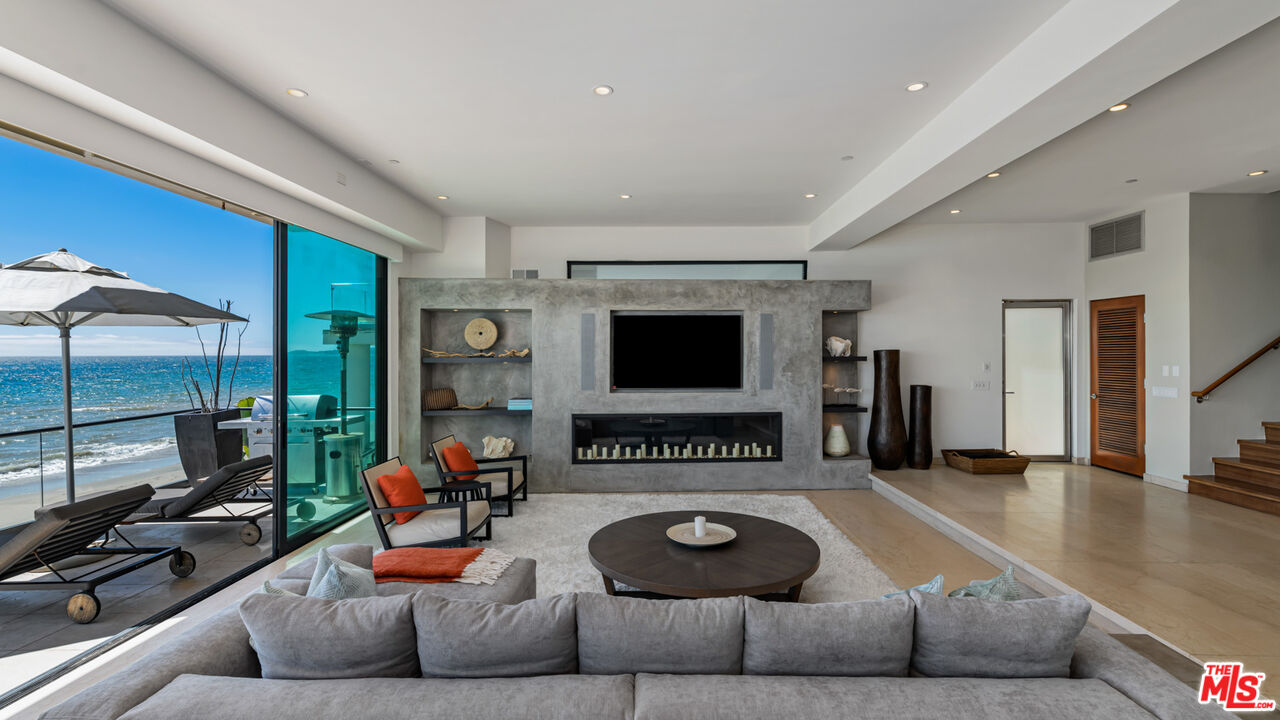 25250 Malibu Road Malibu, CA 90265 - Photo 18 of 66 a living room with furniture and a flat screen tv