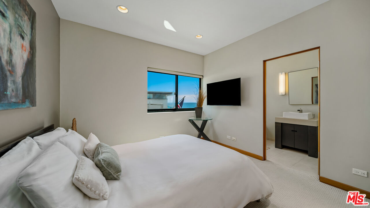 25250 Malibu Road Malibu, CA 90265 - Photo 47 of 66 a bedroom with a bed and a flat screen tv