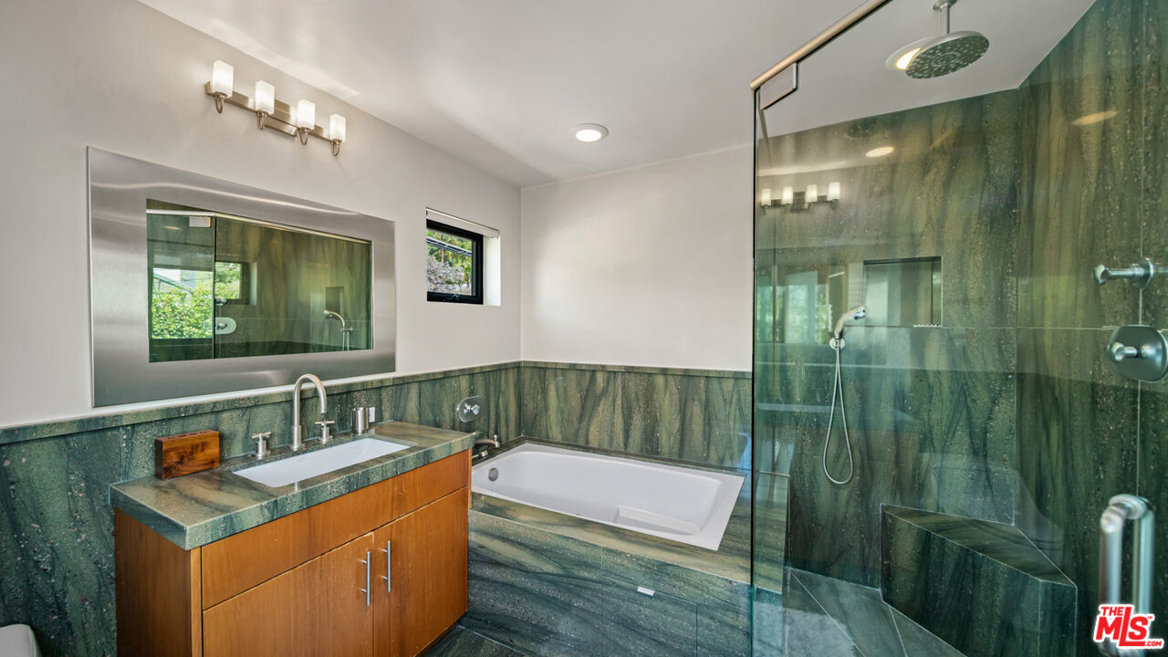 25250 Malibu Road Malibu, CA 90265 - Photo 50 of 66 a bathroom with a sink a mirror and a shower