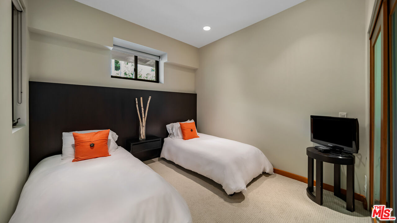 25250 Malibu Road Malibu, CA 90265 - Photo 54 of 66 a bedroom with bed and a flat screen tv