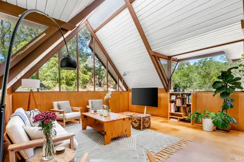 a view of balcony with furniture and garden
