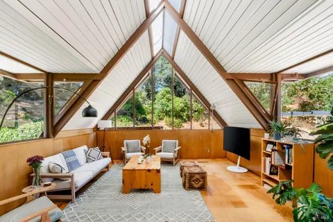 a living room with patio furniture and a floor to ceiling window