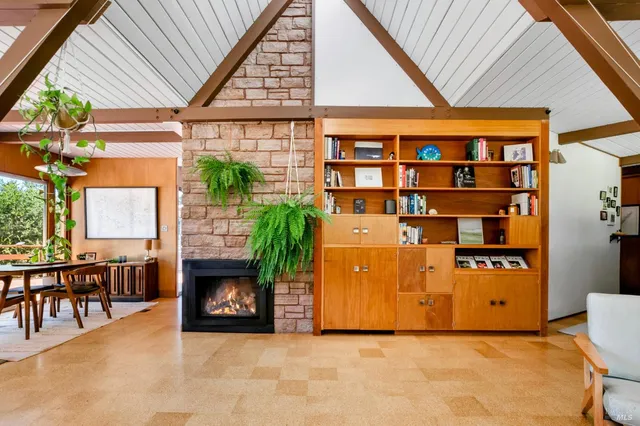a dining room with furniture and a potted plant