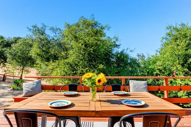 a patio with glass top table and chairs