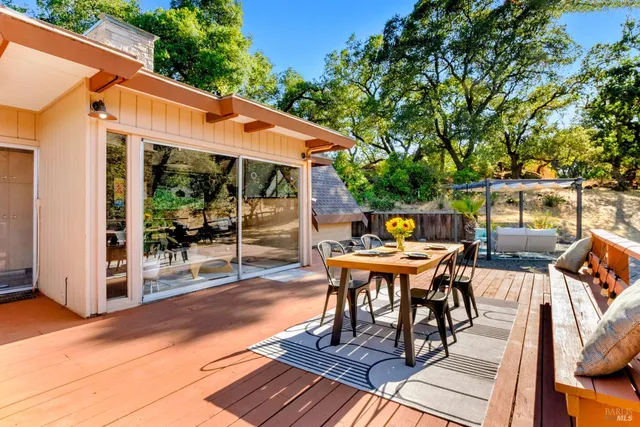 a view of an outdoor dining space with a table and chairs