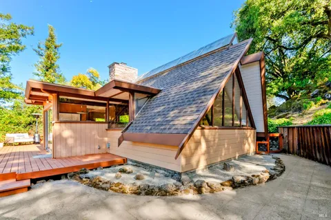 a backyard of a house with table and chairs