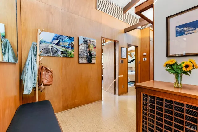 a living room filled with furniture and a floor to ceiling window