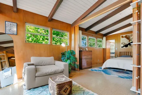 a bed sitting in a bedroom next to a window