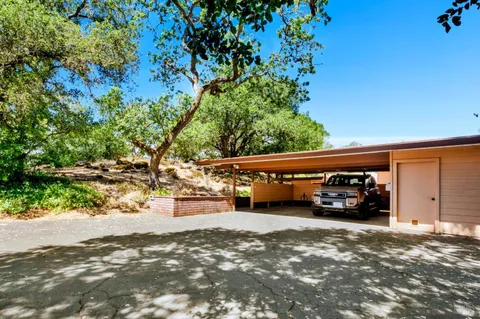 a backyard of a house with table and chairs