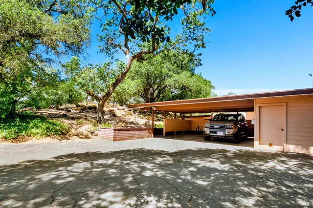 a backyard of a house with table and chairs