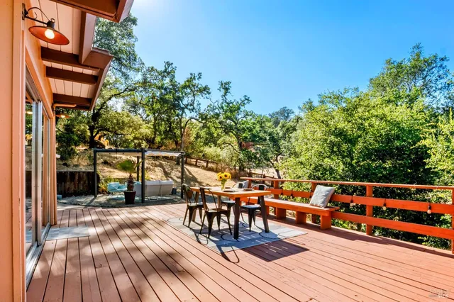 a view of a patio with table and chairs potted plants with wooden fence