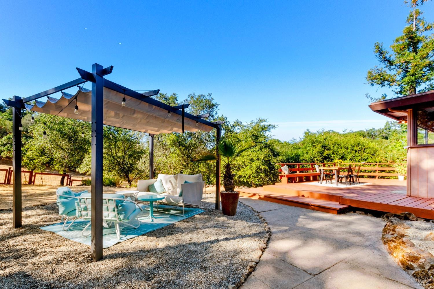 2140 Hyland Court Santa Rosa, CA 95404 - Photo 45 of 51 a view of a patio with table and chairs potted plants with wooden fence
